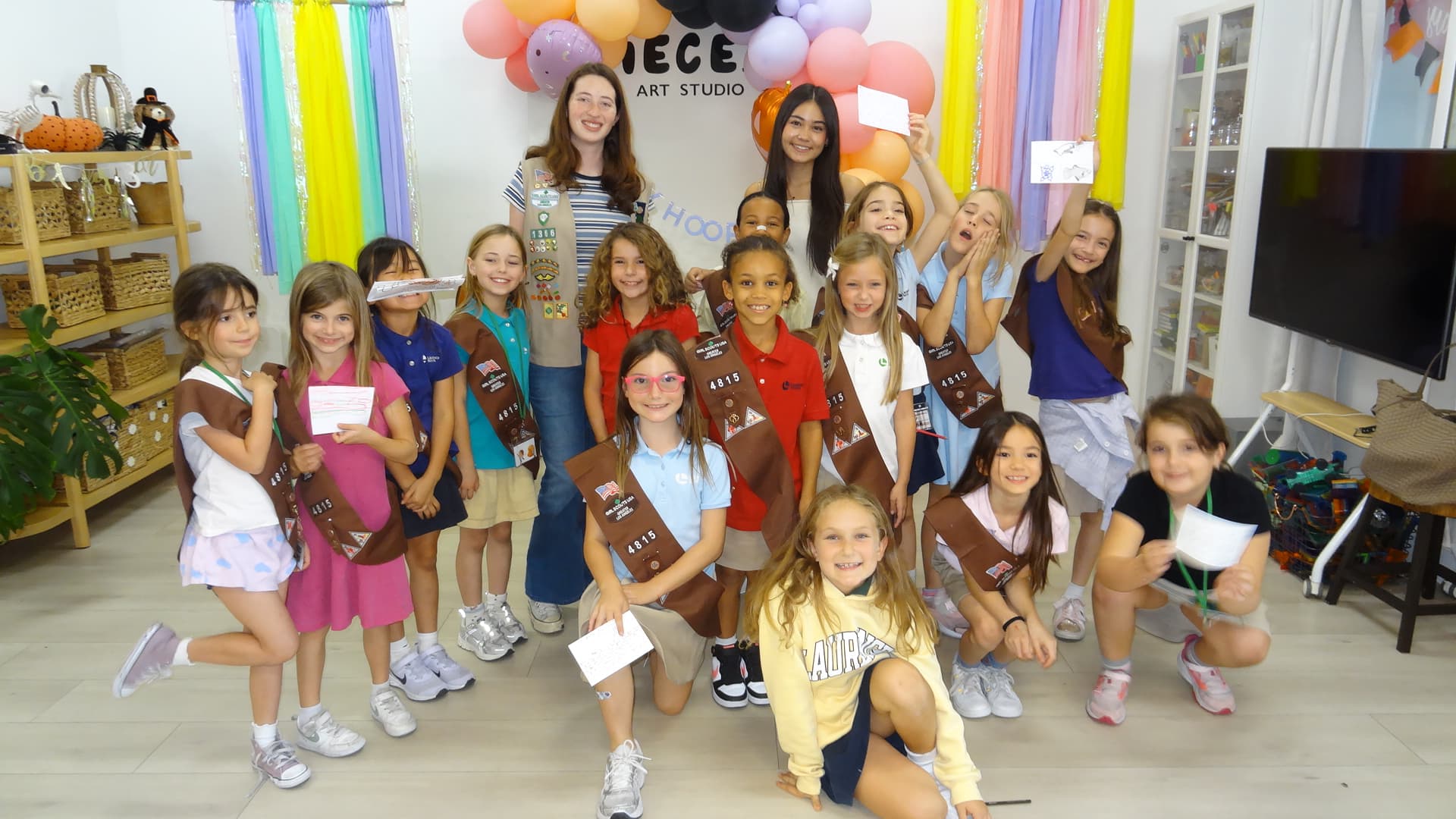 A Girl Scout troop celebrating after a Junior Speakers workshop